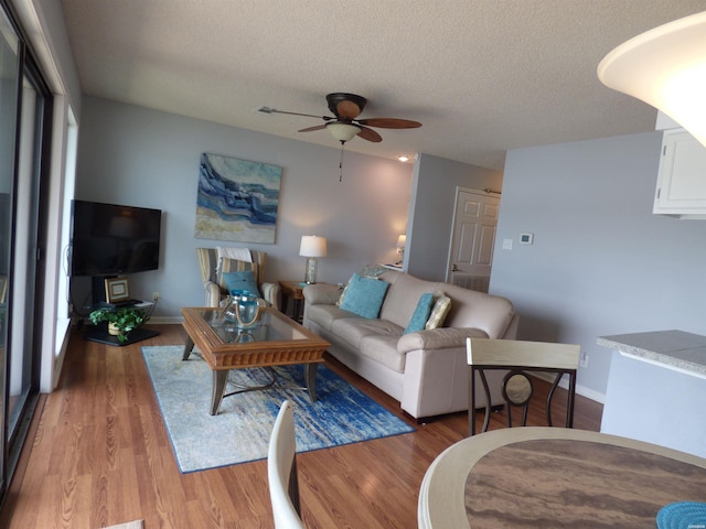 400 Farr Shores Dr Unit 2E, Hot Springs, AR 71913 - living area featuring a ceiling fan, a textured ceiling, light wood-style floors, and baseboards