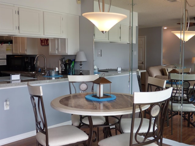 400 Farr Shores Dr Unit 2E, Hot Springs, AR 71913 - kitchen with dark wood-style flooring, white cabinets, a sink, and fridge
