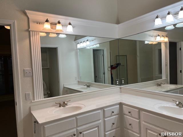 full bathroom featuring a sink and double vanity