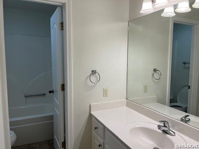 bathroom with toilet, tile patterned flooring, and vanity