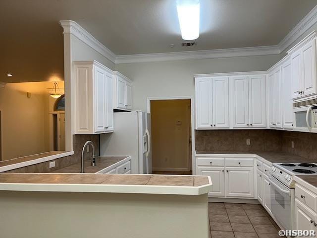 kitchen featuring light tile patterned floors, white appliances, backsplash, and ornamental molding