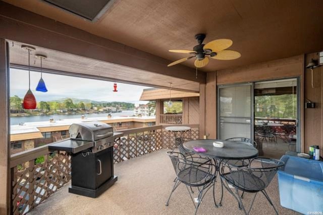 view of patio / terrace featuring outdoor dining area, a water view, ceiling fan, and grilling area