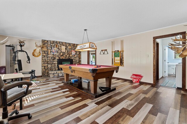 recreation room featuring a fireplace, pool table, ornamental molding, wood finished floors, and baseboards