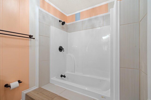 full bathroom featuring crown molding and a textured ceiling