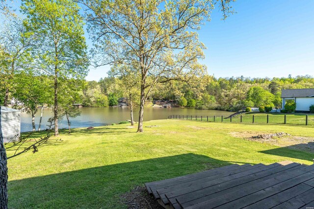 view of yard with a water view and fence