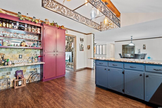 kitchen featuring pendant lighting, open shelves, lofted ceiling, light countertops, and dark wood-type flooring