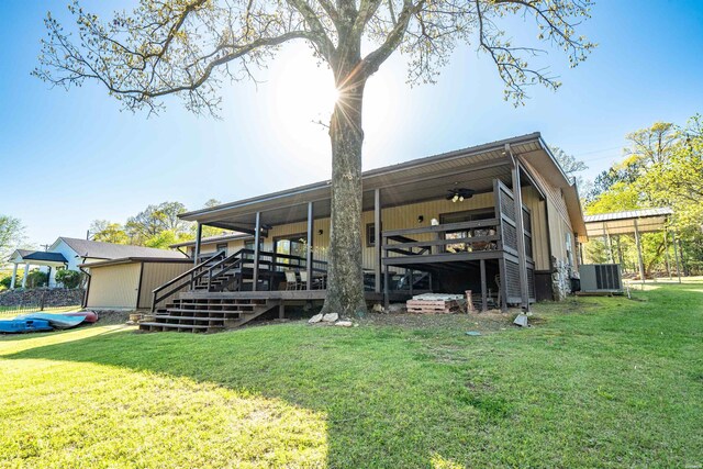 rear view of house with ceiling fan, a yard, central AC unit, and a wooden deck