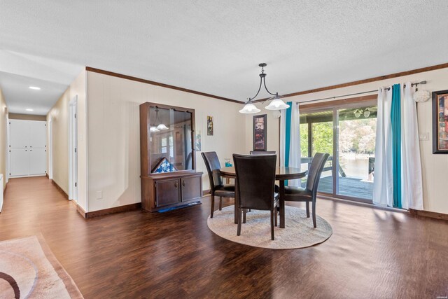 dining area featuring crown molding, baseboards, dark wood finished floors, and a textured ceiling