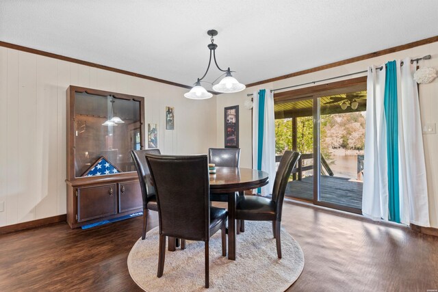 dining area featuring baseboards, ornamental molding, and dark wood finished floors