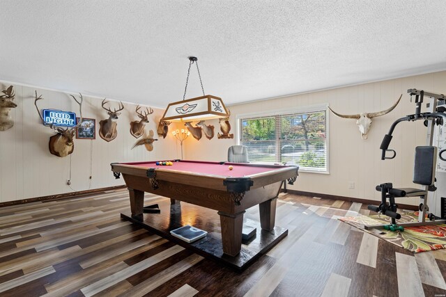 rec room with a textured ceiling, baseboards, dark wood-type flooring, and pool table