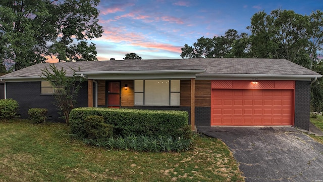 1405 Emory St, Hot Springs, AR 71913 - view of front facade featuring driveway, a garage, brick siding, covered porch, and a yard