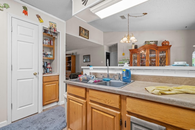 kitchen with decorative light fixtures, light countertops, a notable chandelier, a textured ceiling, and a sink