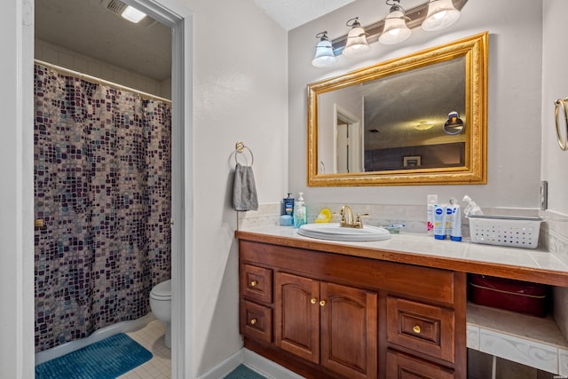 full bathroom featuring curtained shower, toilet, vanity, and tile patterned flooring