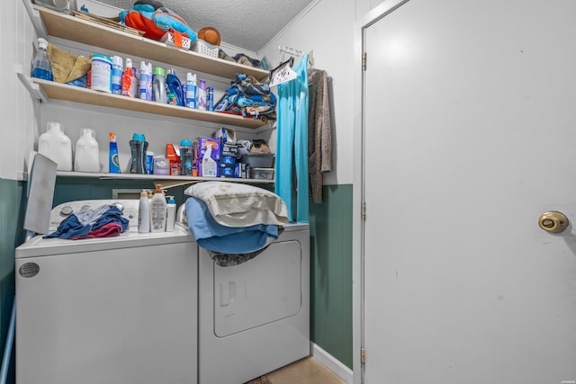 laundry room with laundry area, washing machine and dryer, and a textured ceiling