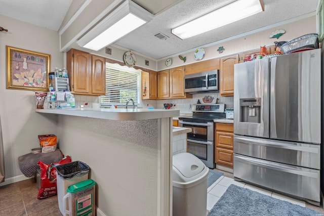 kitchen featuring stainless steel appliances, tasteful backsplash, visible vents, and light countertops