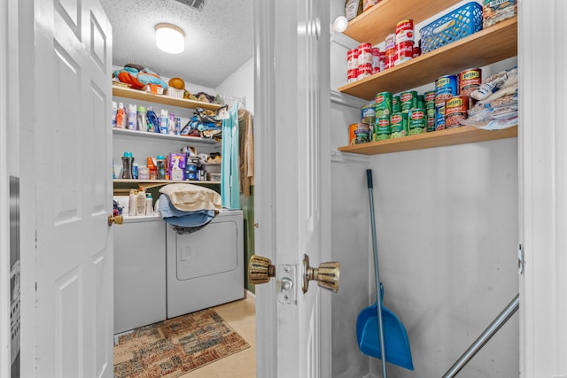 clothes washing area with laundry area and a textured ceiling