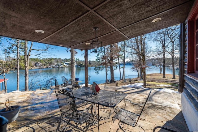 view of patio with outdoor dining area and a water view