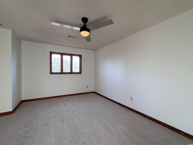 unfurnished room featuring visible vents, light carpet, and baseboards