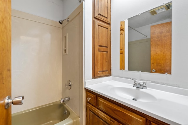 bathroom with visible vents,  shower combination, and vanity