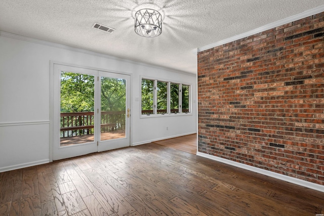 1200 Rock Creek Rd, Hot Springs, AR 71913 - spare room featuring baseboards, crown molding, a textured ceiling, wood-type flooring, and brick wall