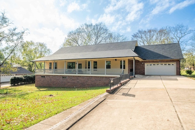 view of front of house with a garage, brick siding, concrete driveway, covered porch, and a front yard