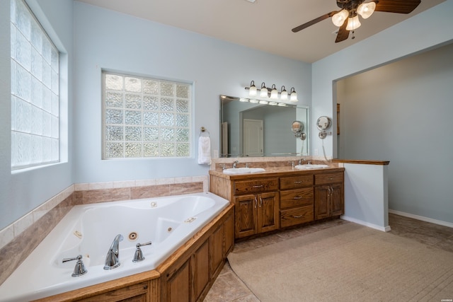 bathroom with ceiling fan, a sink, a jetted tub, and double vanity