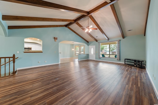 unfurnished living room featuring arched walkways, visible vents, a ceiling fan, dark wood-style floors, and beamed ceiling