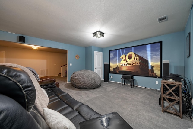 carpeted cinema room with a textured ceiling and visible vents