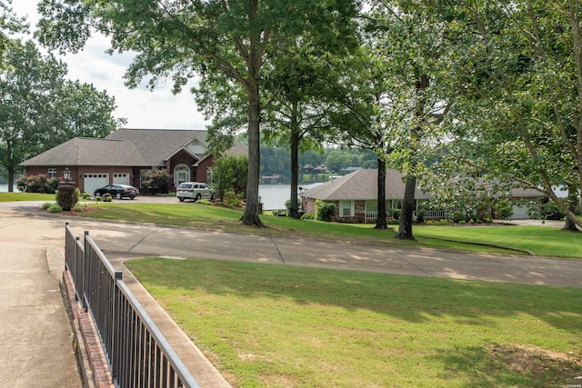 view of yard featuring a water view and fence