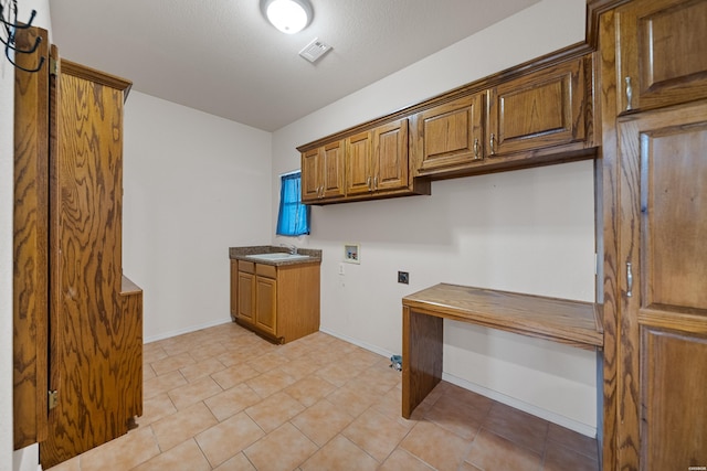 washroom featuring washer hookup, cabinet space, a sink, electric dryer hookup, and baseboards