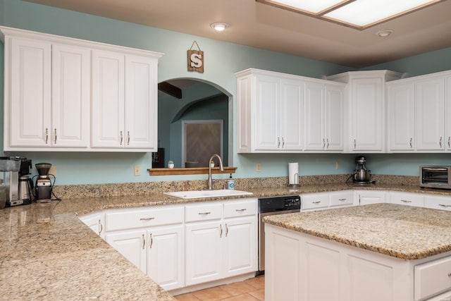 kitchen featuring a sink and white cabinetry