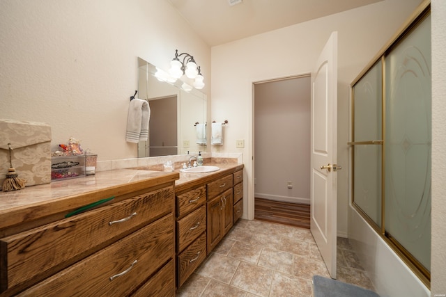 bathroom with shower / bath combination with glass door and vanity