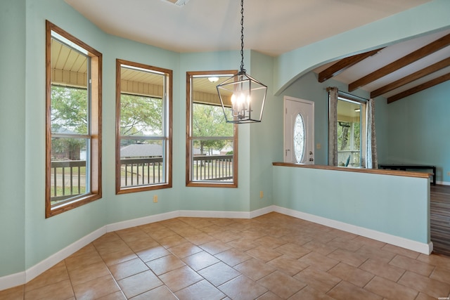 unfurnished room with baseboards, arched walkways, beamed ceiling, a notable chandelier, and light tile patterned flooring