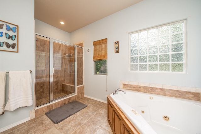 bathroom featuring a tub with jets, a stall shower, and baseboards