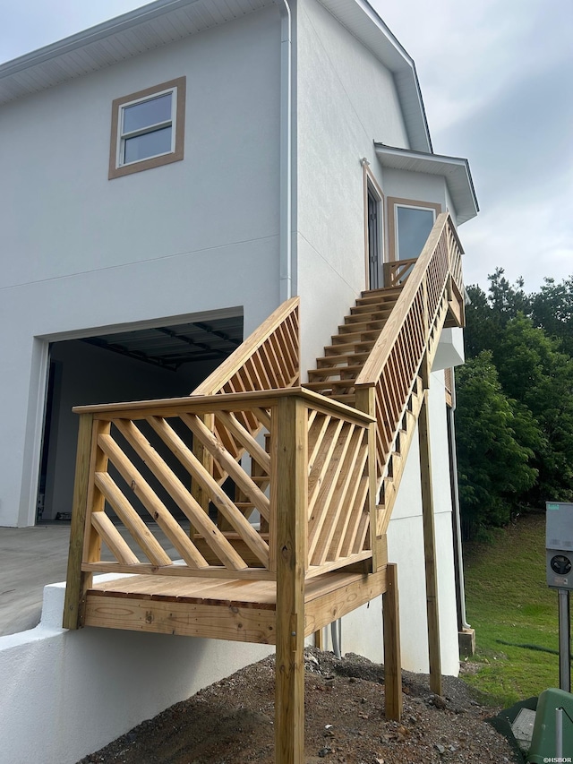 208 Aberina Unit G, Hot Springs, AR 71913 - view of home's exterior featuring stairway and stucco siding