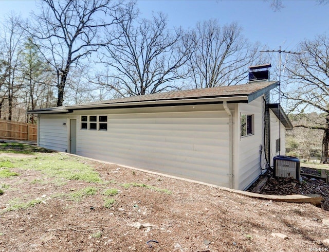 garage with cooling unit and fence