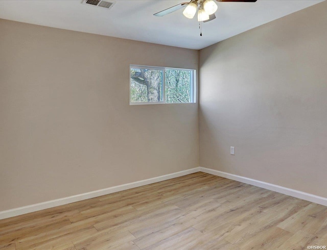 unfurnished room with visible vents, baseboards, light wood-type flooring, and ceiling fan