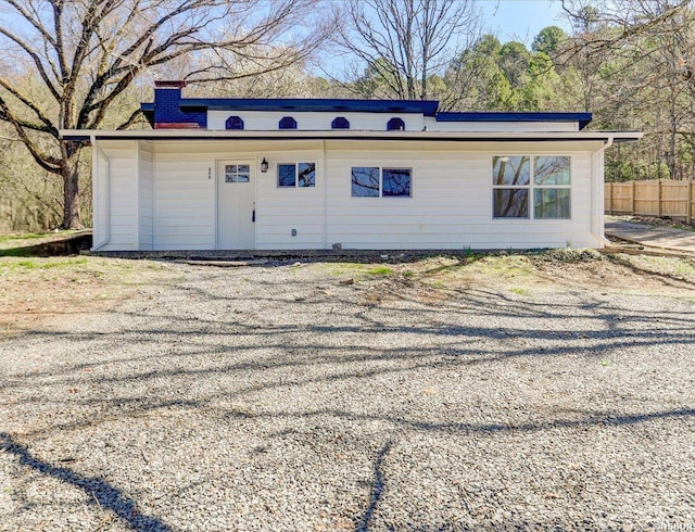 exterior space with fence and a chimney