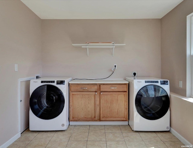 laundry room with light tile patterned floors, cabinet space, washer / clothes dryer, and baseboards