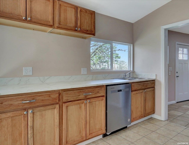 kitchen featuring a healthy amount of sunlight, dishwasher, brown cabinets, and a sink