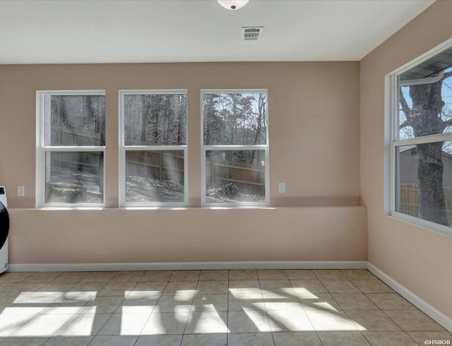 spare room with tile patterned floors, baseboards, and visible vents