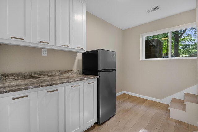 106 Grissom Trl, Hot Springs, AR 71913 - kitchen with freestanding refrigerator, white cabinetry, light wood finished floors, and baseboards