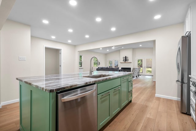 106 Grissom Trl, Hot Springs, AR 71913 - kitchen with green cabinetry, appliances with stainless steel finishes, a sink, an island with sink, and baseboards