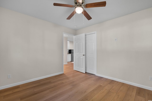 106 Grissom Trl, Hot Springs, AR 71913 - spare room with baseboards, light wood-style floors, and a ceiling fan