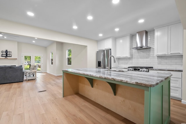 106 Grissom Trl, Hot Springs, AR 71913 - kitchen with wall chimney range hood, stainless steel refrigerator with ice dispenser, a sink, white cabinets, and decorative backsplash