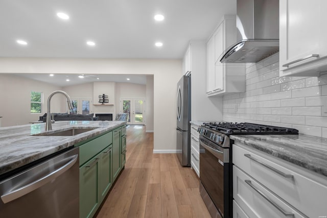 106 Grissom Trl, Hot Springs, AR 71913 - kitchen featuring stainless steel appliances, green cabinets, wall chimney exhaust hood, a sink, and white cabinets