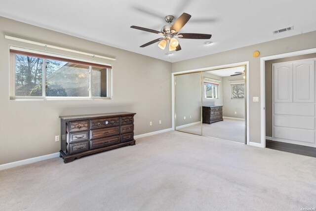 bedroom featuring baseboards, visible vents, and light colored carpet