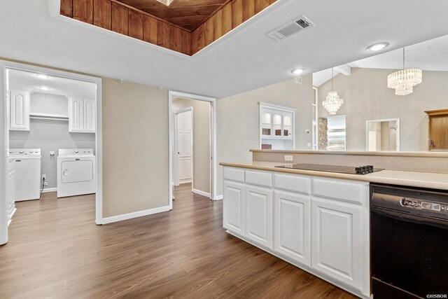 kitchen with decorative light fixtures, light countertops, visible vents, and washer and clothes dryer