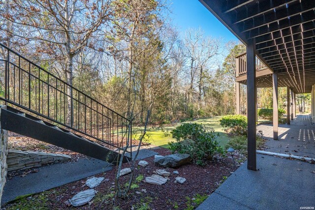 view of yard featuring a patio area and stairs