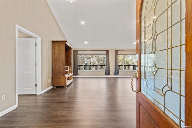 entryway featuring lofted ceiling, baseboards, dark wood-type flooring, and recessed lighting